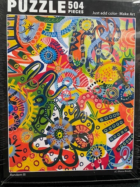 Colorful puzzle 4 packaging with abstract designs and 'Puzzle 504 Pieces' text.