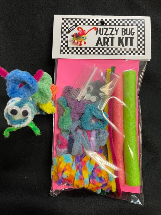 A packaged 'Fuzzy Bug Art Kit' with various colorful crafting materials visible through the clear plastic, including pipe cleaners and beads, with a cartoonish blue and pink fuzzy bug toy included.