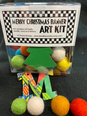 A Christmas-themed arts and crafts kit, including a felt tree, felt balls in various colors, and decorative letters, packaged in a clear plastic container with a label.